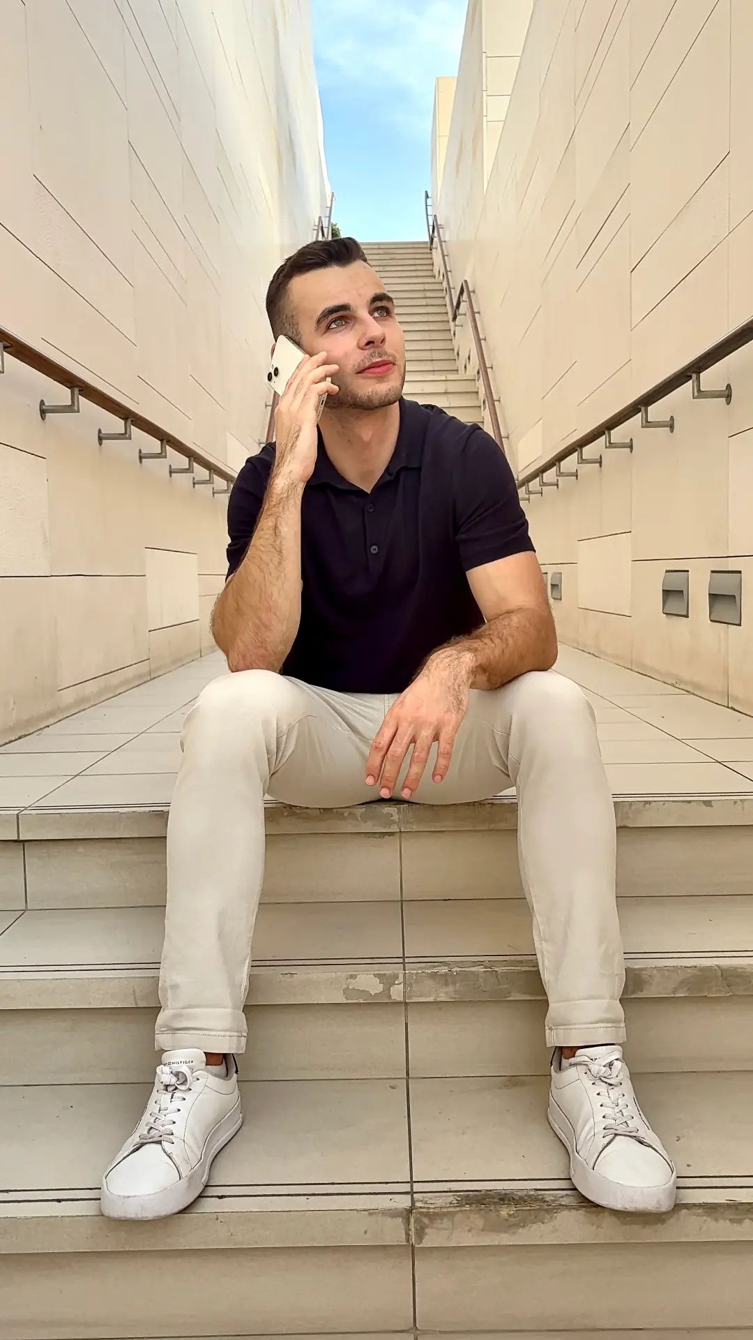 Dominik Krásl telefonuje na schodech